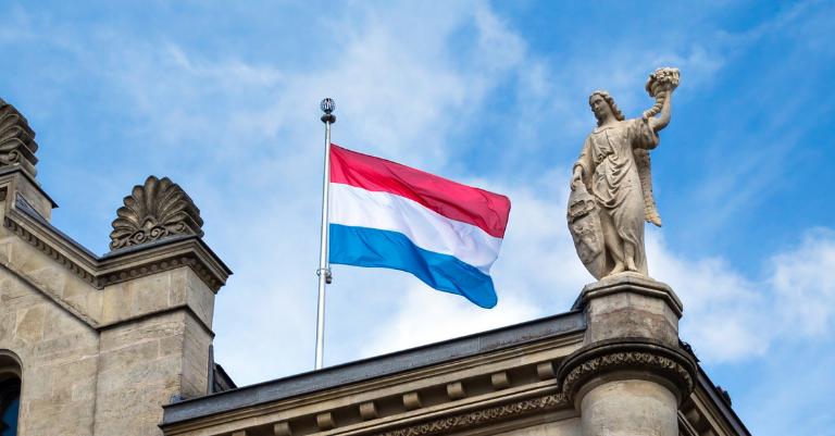 Luxembourg flag flying over building